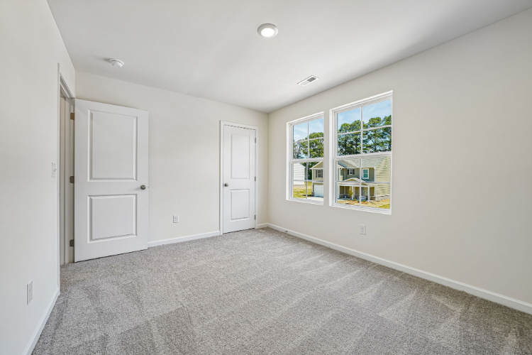 A room with white walls and a window.