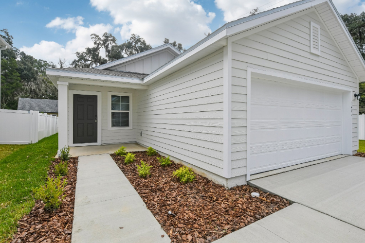 A white house with a driveway.