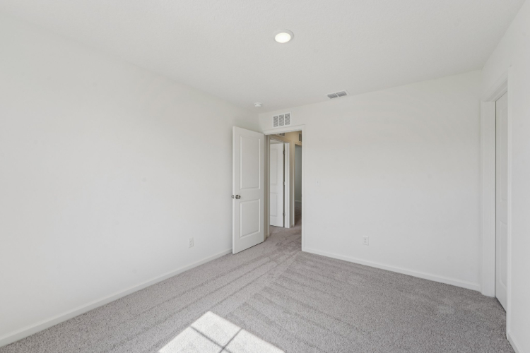 A hallway with white walls.