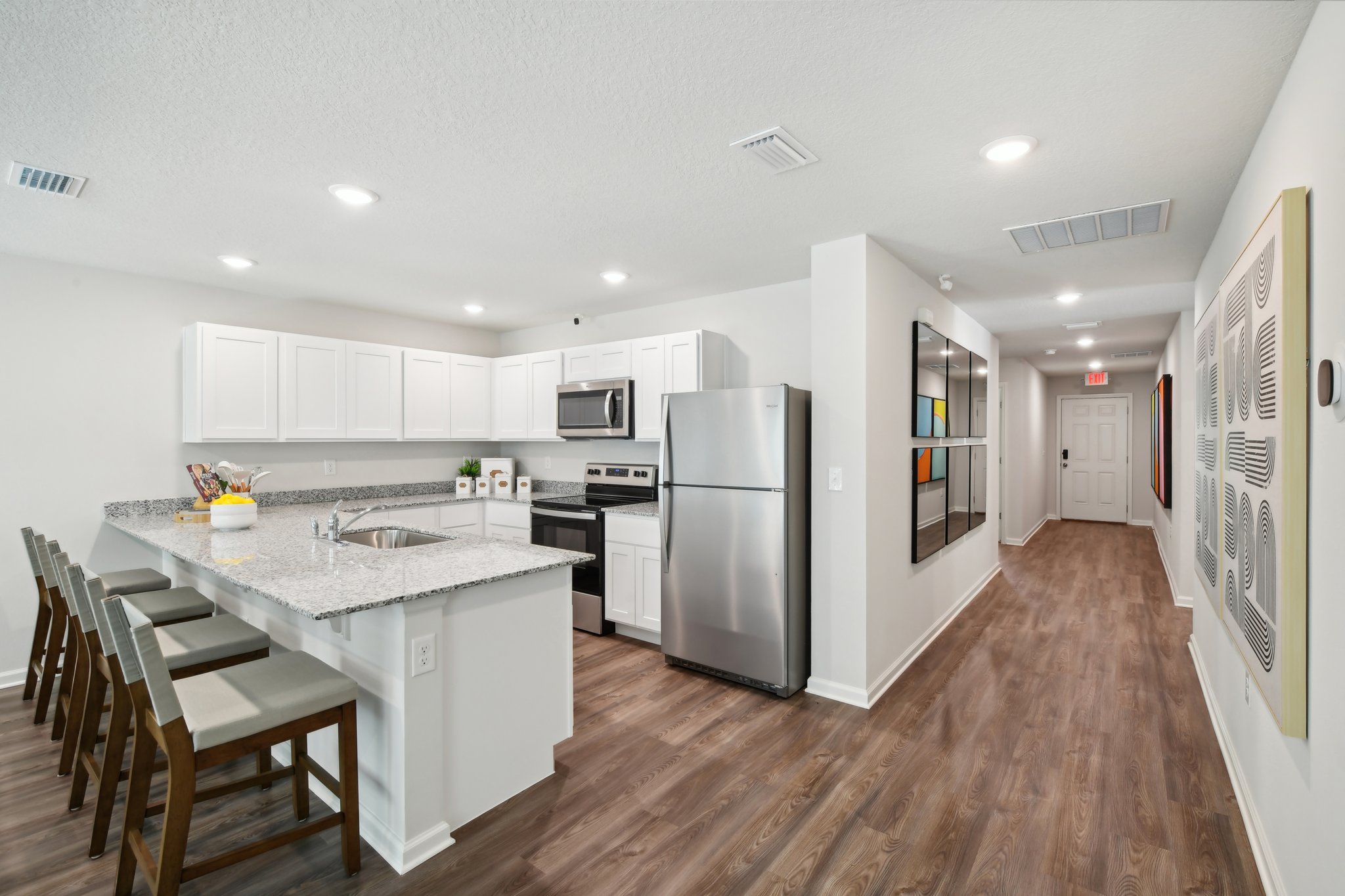 A kitchen with white cabinets.