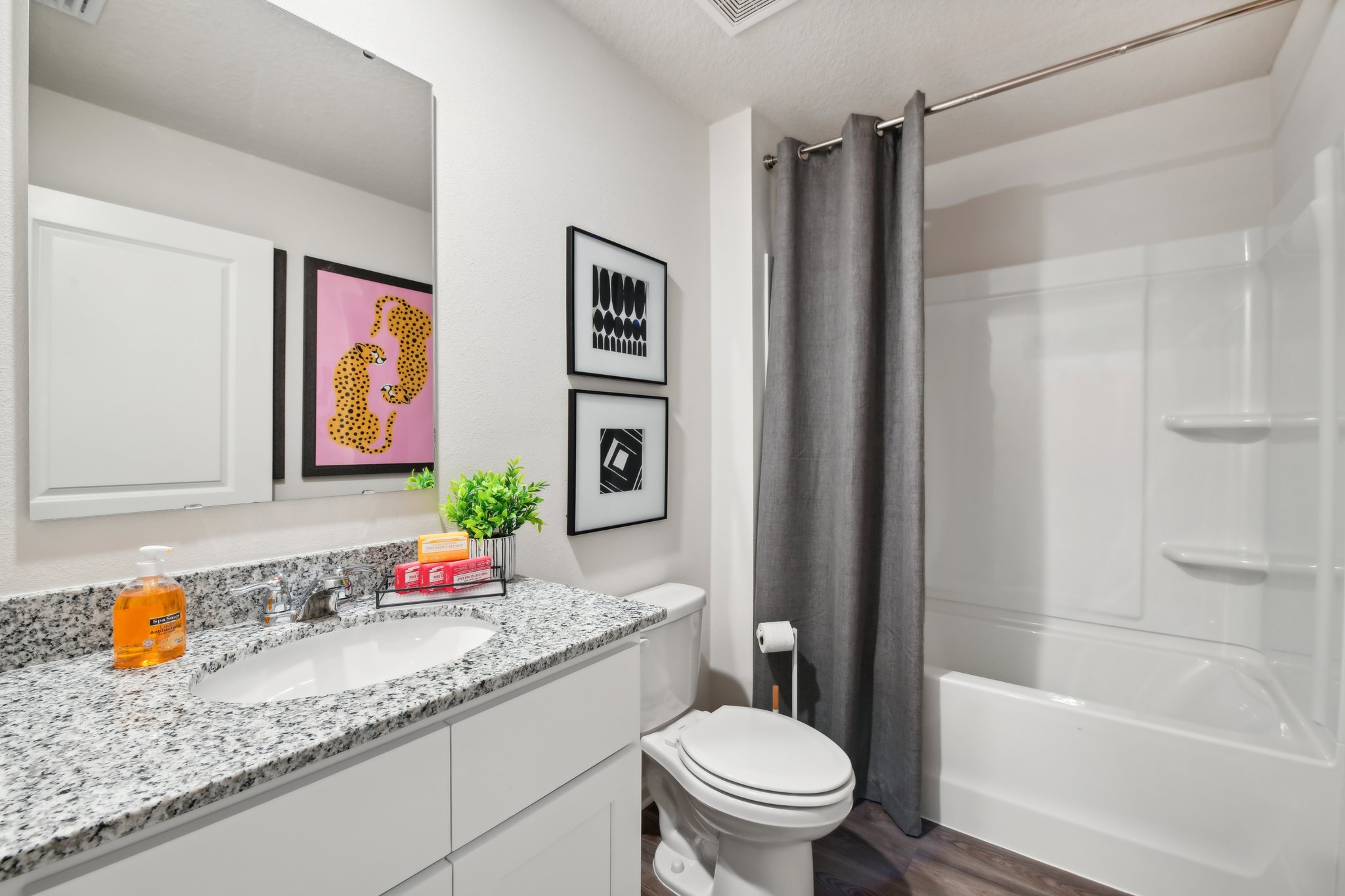 A bathroom with a tub sink and toilet.