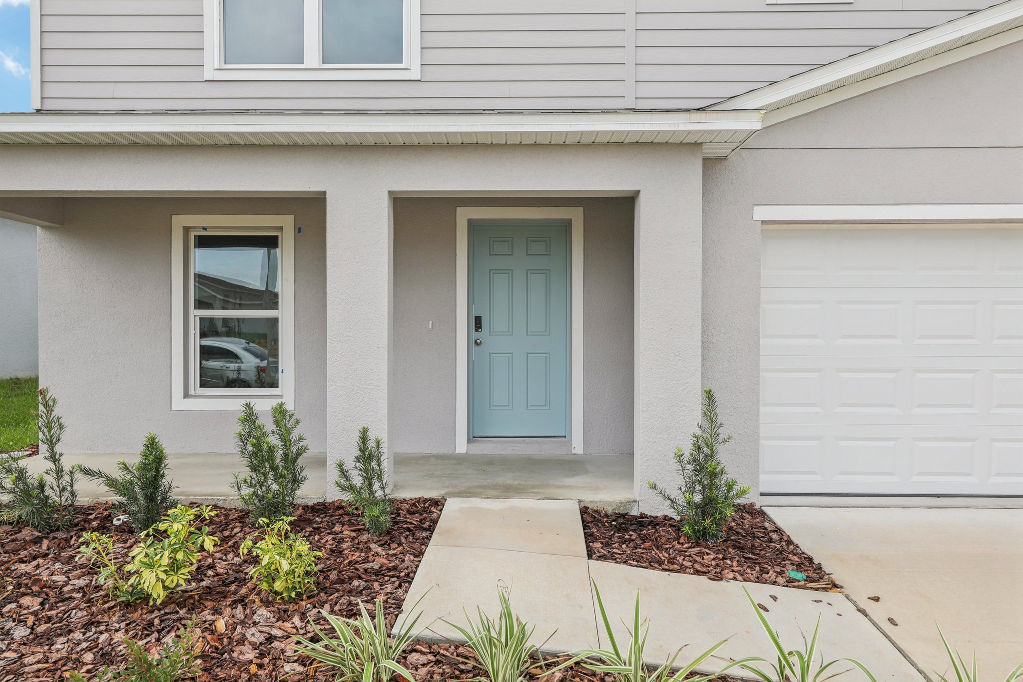 A white house with a blue door.