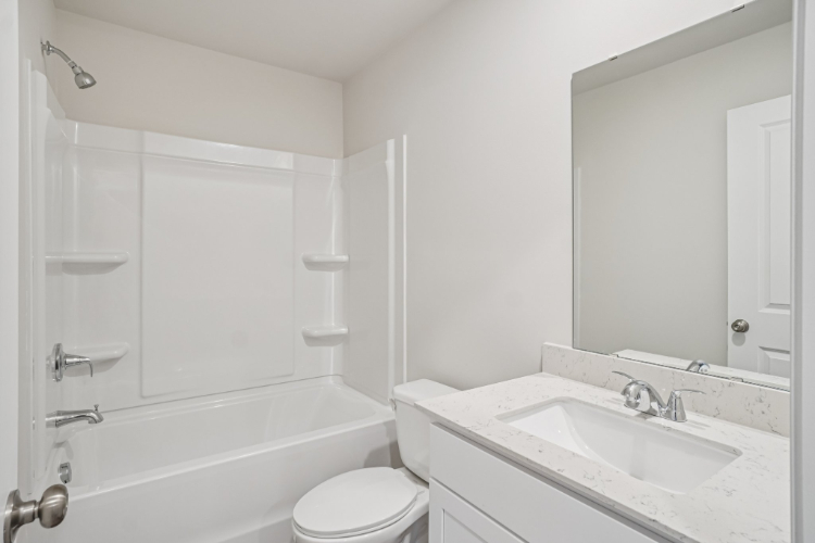 A bathroom with a sink toilet and bathtub.