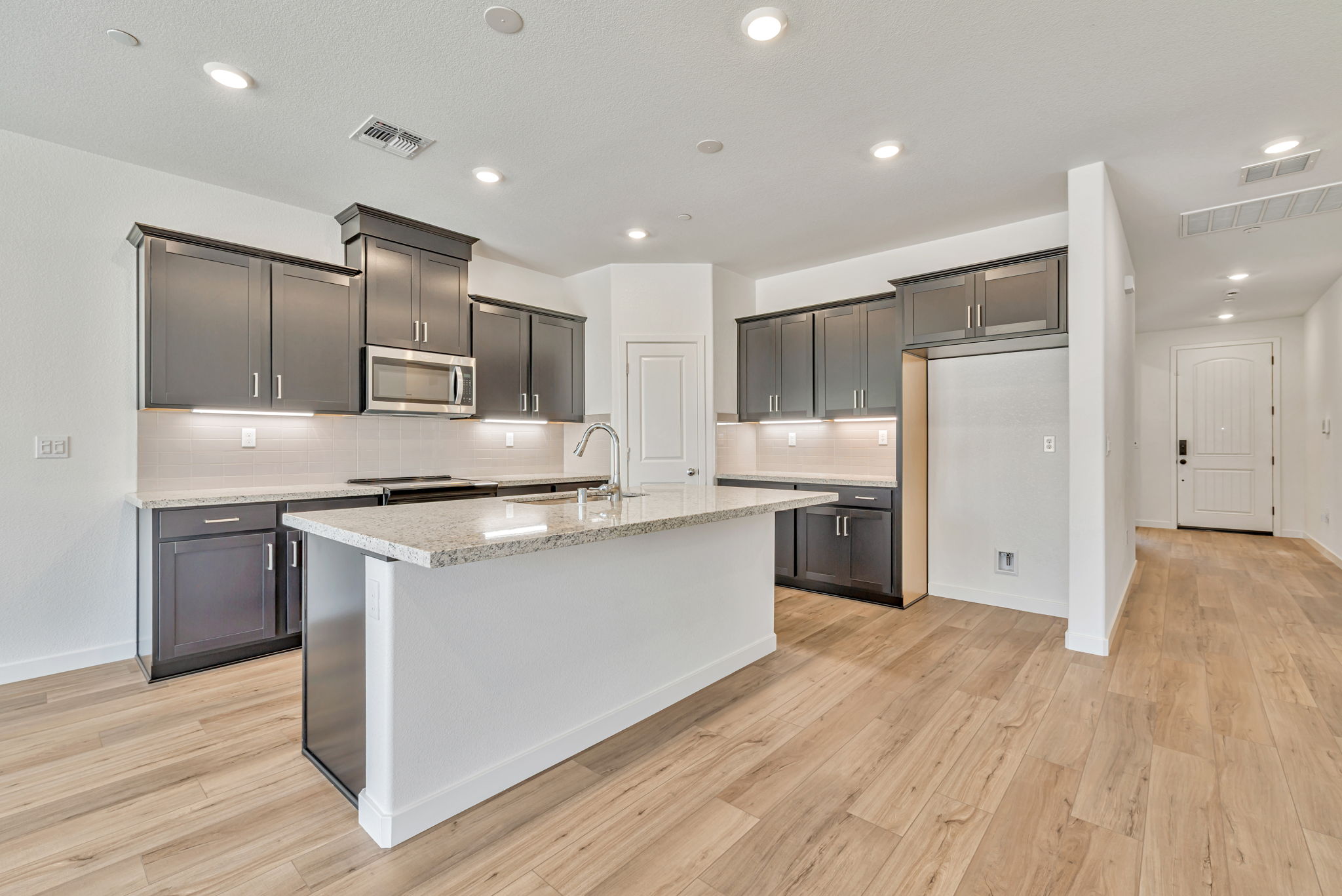 A kitchen with black cabinets.