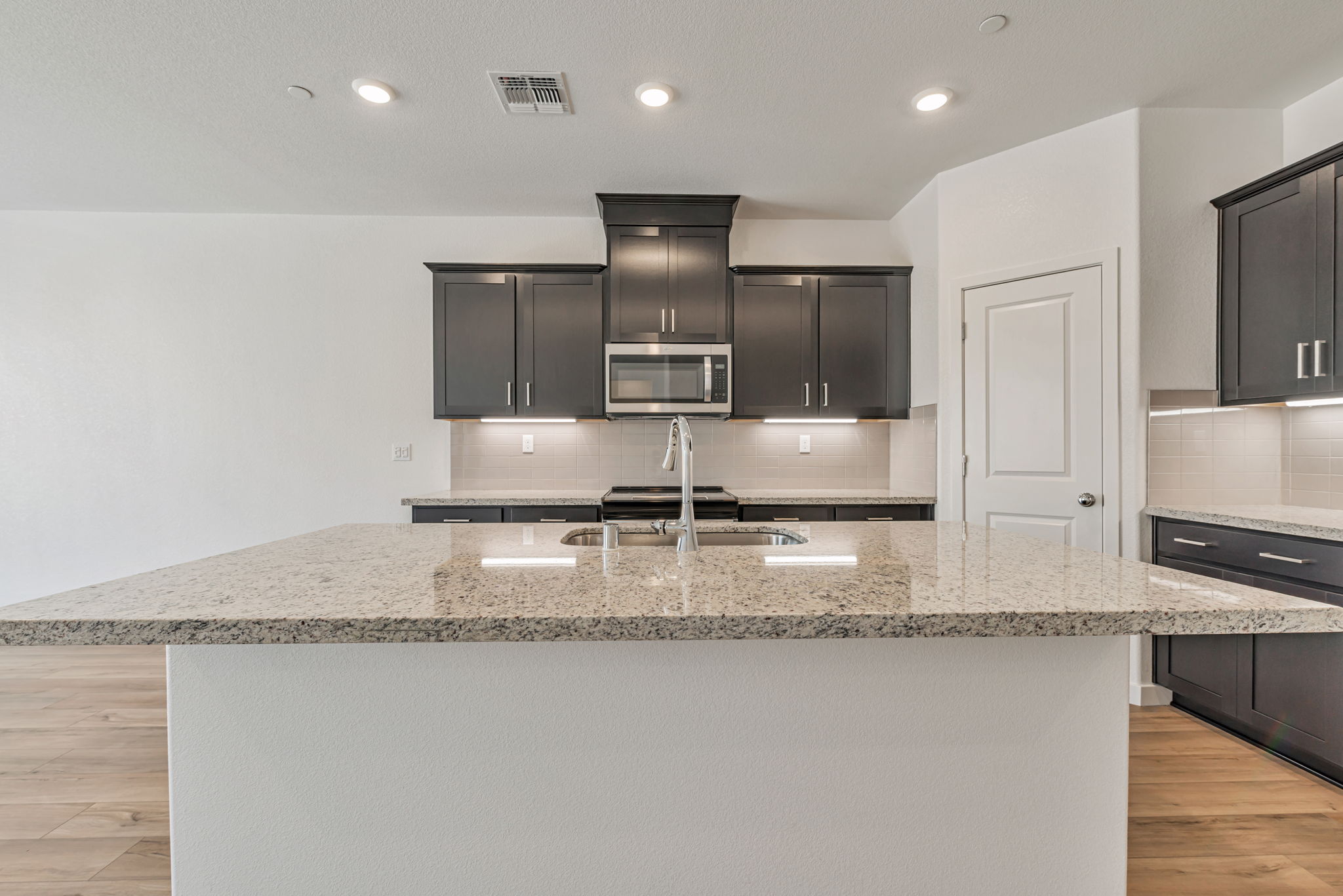 A kitchen with black cabinets.